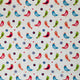 A close-up of a fabric pattern featuring colourful stylized birds in red, blue, green, and orange on a warm white background, accented with small red hearts and dark blue floral motifs.