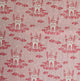 A close-up of a pink fabric with a repeating pattern of red castles rising from pink clouds, with small white stars scattered throughout.