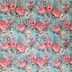 A repeating floral pattern featuring pink and white roses with green leaves on a light blue background.