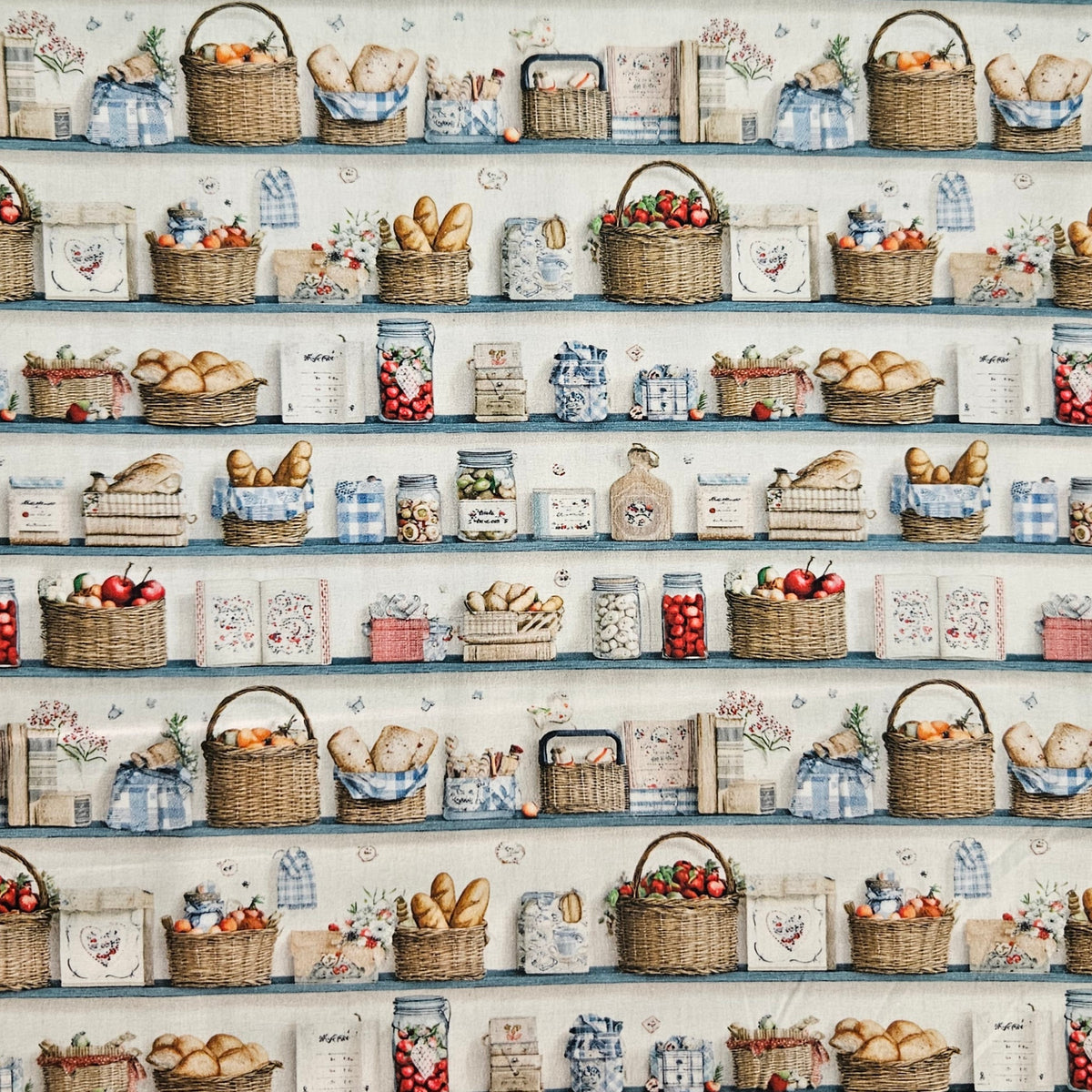 A repeating pattern of rustic shelves filled with woven baskets, bread loaves, jars of fruit and preserves, flowers, and small blue-and-white check fabrics on a light background.