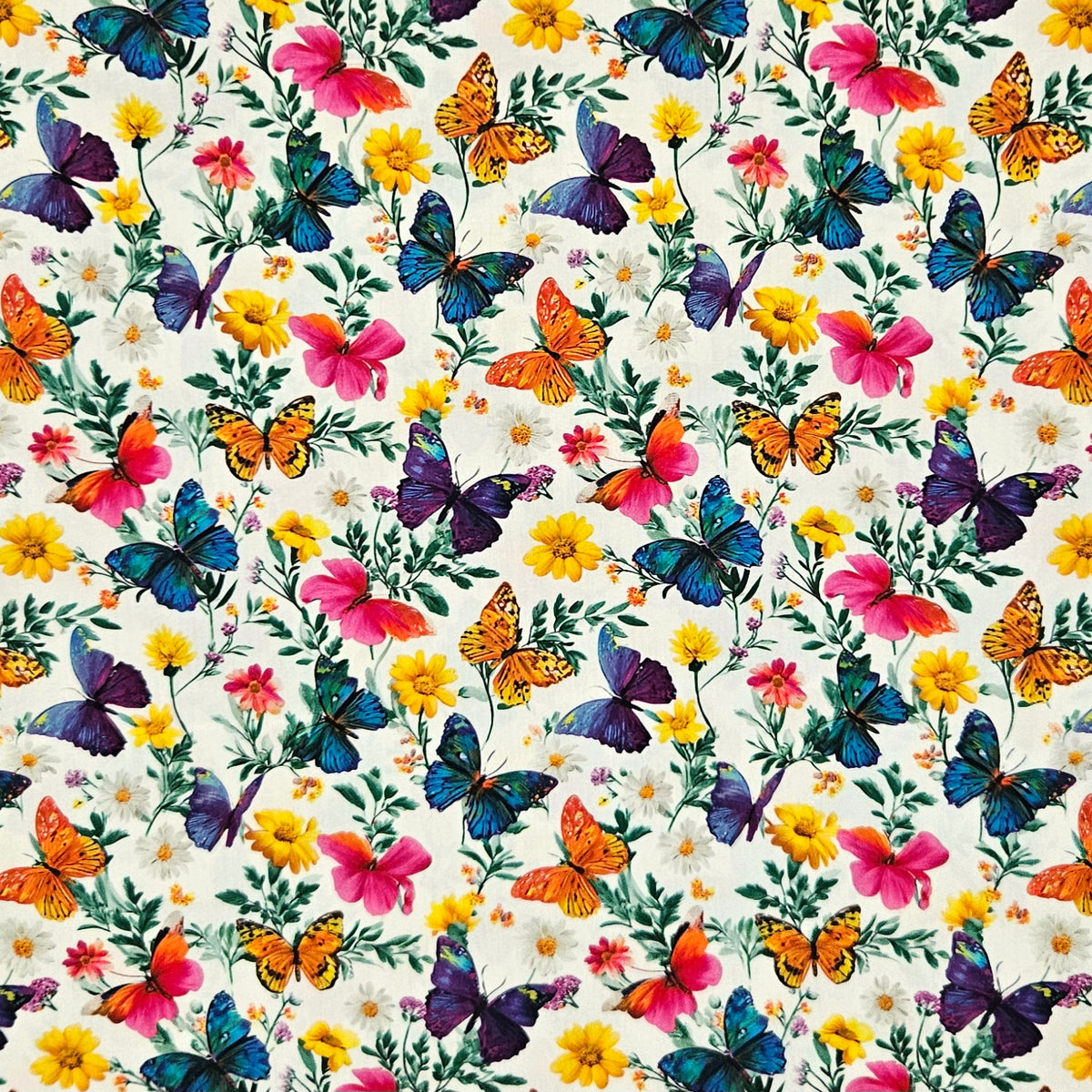 A repeating floral and butterfly pattern on a warm off-white background, featuring colorful butterflies in blue, purple, orange, yellow, and pink with green leaves and small white, yellow, and pink flowers.