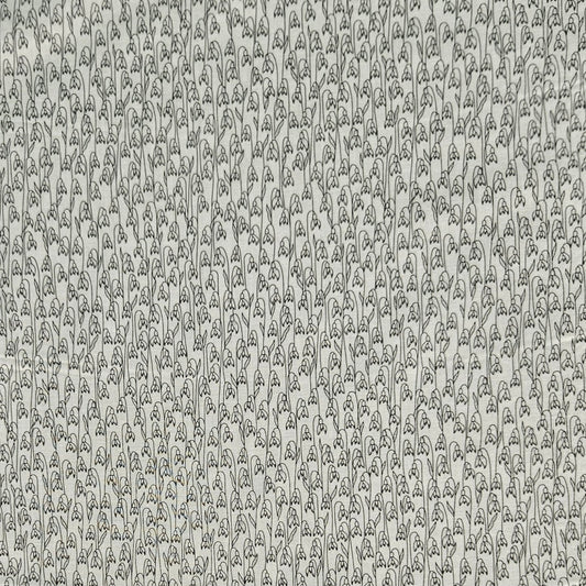 A close-up of a repeating pattern featuring hand-drawn black line illustrations of lily-of-the-valley flowers on a warm off-white background.