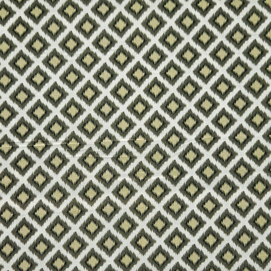 A close-up of a woven fabric with a repeating geometric diamond pattern in olive green, cream, and light beige.