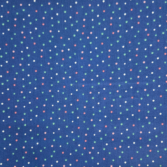 A close-up of a blue fabric with a repeating pattern of small multicolored polka dots in white, green, and pink.