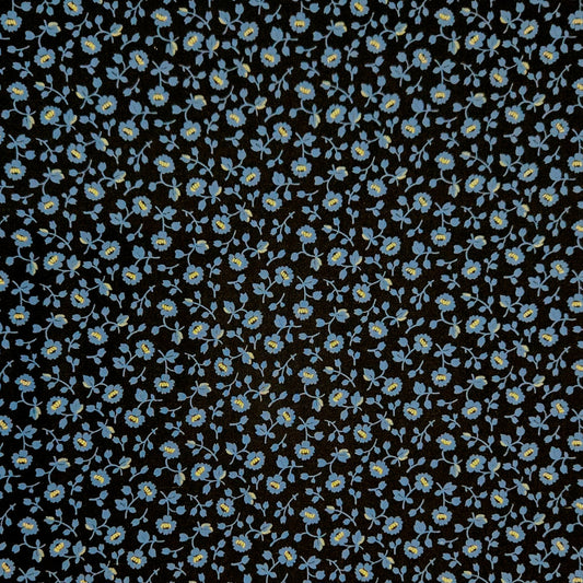 A close-up of a fabric pattern featuring small light blue and yellow flowers with green stems on a solid black background.