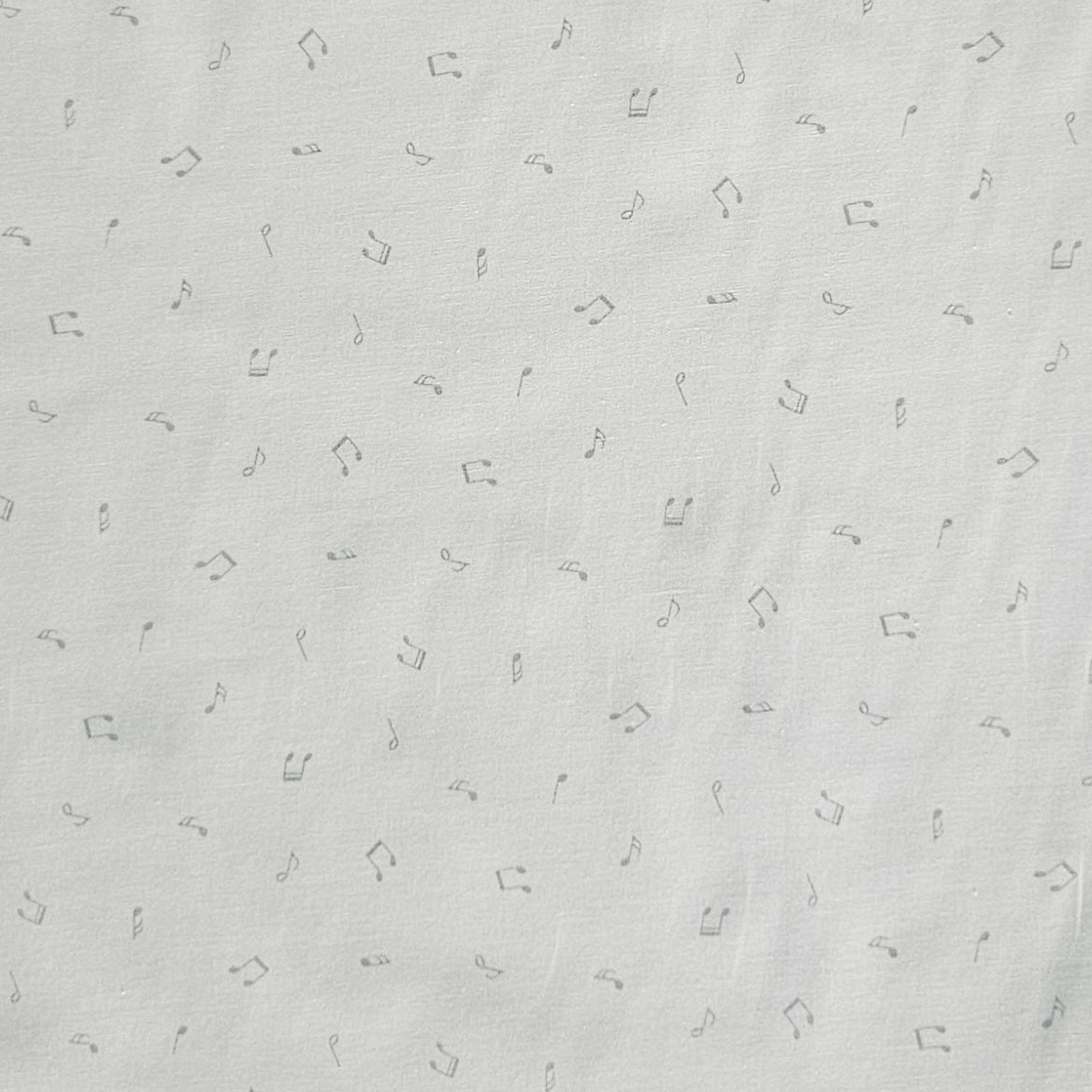 White fabric with a delicate pattern of small gray musical notes and quarter rests.